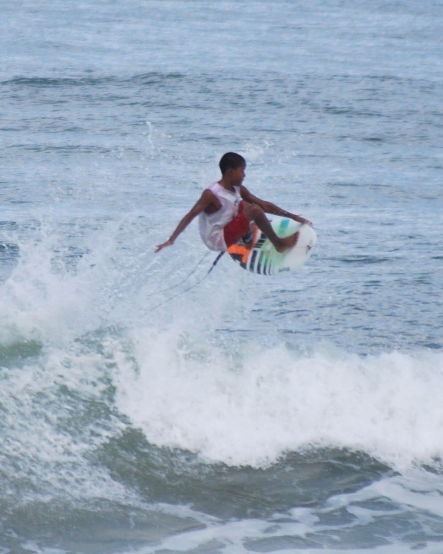 A young surfer catching air on a wave